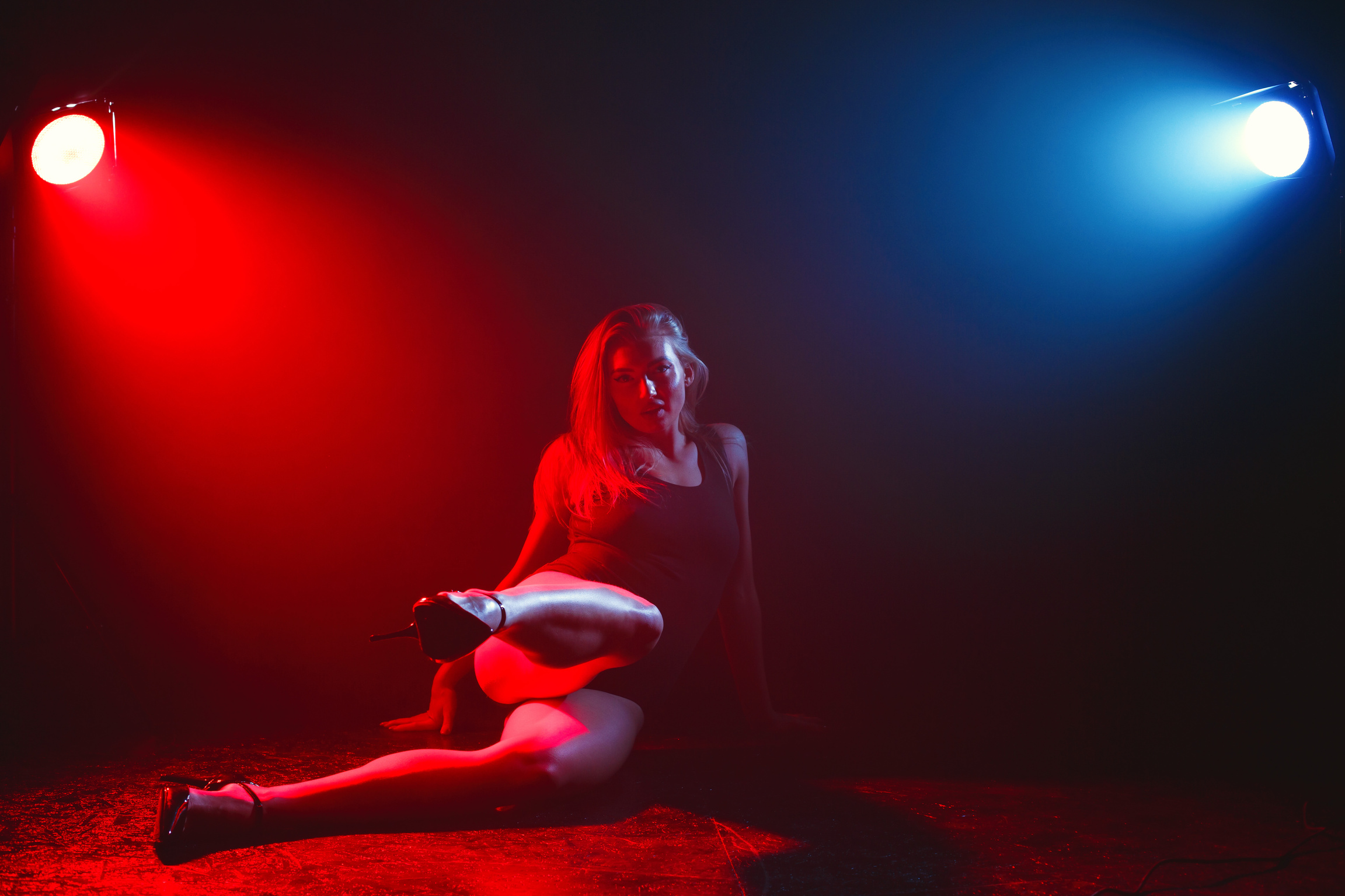 Photo of a Woman Illuminated by Red and Blue Lights